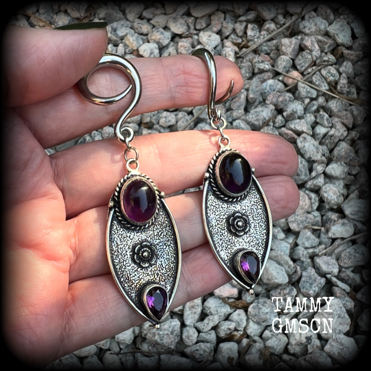 Featuring beautiful purple amethyst gemstones in a boho antique silver setting , this pair of earrings weighs approx 8 grams a piece and measure just under 8cms from tip to tip.

This pair have been made on 6 gauge (4mm) surgical steel full curl hooks, to be worn in stretched lobes.