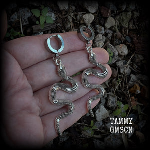 These awesome earrings feature an antique silver snake, are nice and lightweight at 7 grams each, and measure in at approx 7cms from tip to tip.

This pair have been made on stainless steel huggie ear cuffs, suitable for pierced ears.