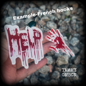 These awesome horror movie inspired earrings feature a bloodied hand print alongside ‘HELP’ finger painted in blood, measuring approx 7.5cms from tip to tip, and weigh only a few grams each.

This pair has been made with stainless steel french hooks, suitable for pierced ears.