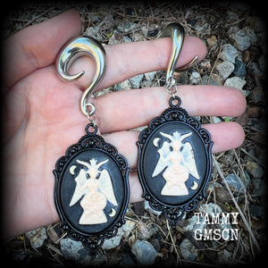Featuring gorgeous ivory and black enamel Baphomet pendants, these gauged earrings measure just on 10.5cms from tip to tip, and weigh approx 32 grams each.

This pair have been made on 00 gauge (10mm) surgical steel full curls, to be worn in stretched lobes.