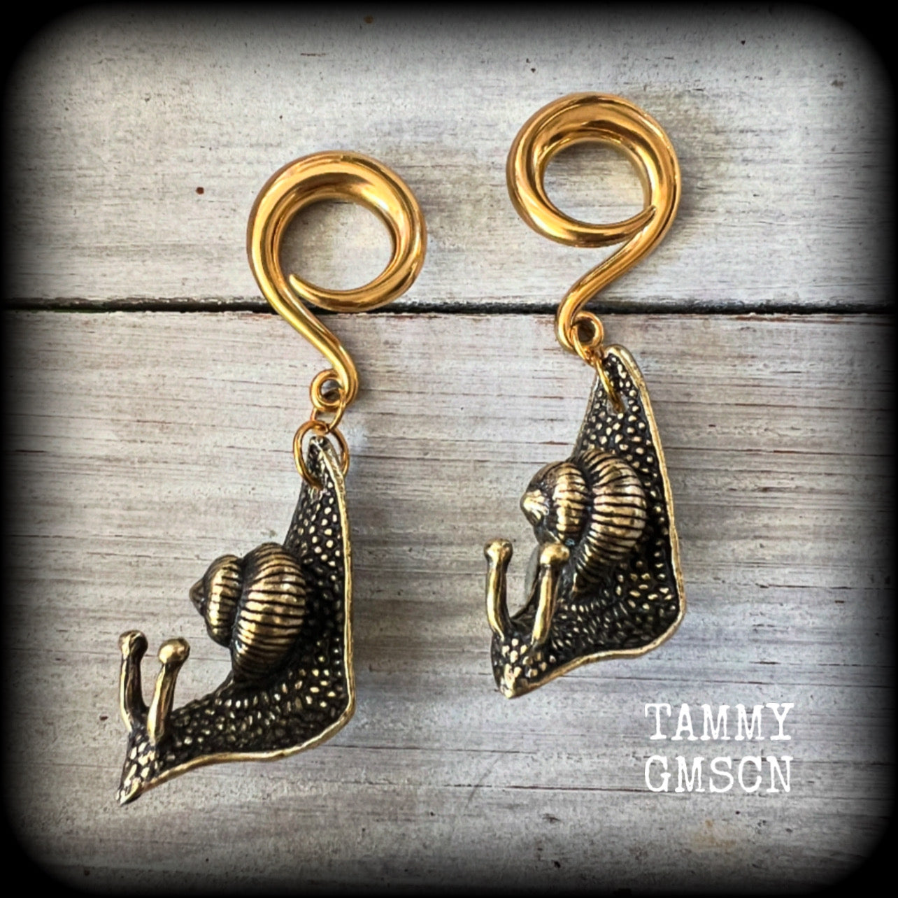 These awesome brass snail ear hangers feature gorgeous brass garden snails, measuring just on 7.5cms from tip to tip, and weighing approx 30 grams each.

This pair has been made on 2 gauge (6mm) surgical steel full curls, suitable for stretched lobes.