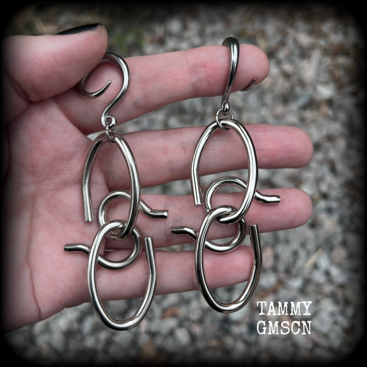 These awesome gauged earrings feature twisted and knotted surgical steel pieces, weighing approx 18 grams a piece, and nice and dangly at just over 9cms from tip to tip.

This pair has been made on 6 gauge (4mm) surgical steel full curl hooks, suitable for stretched lobes.