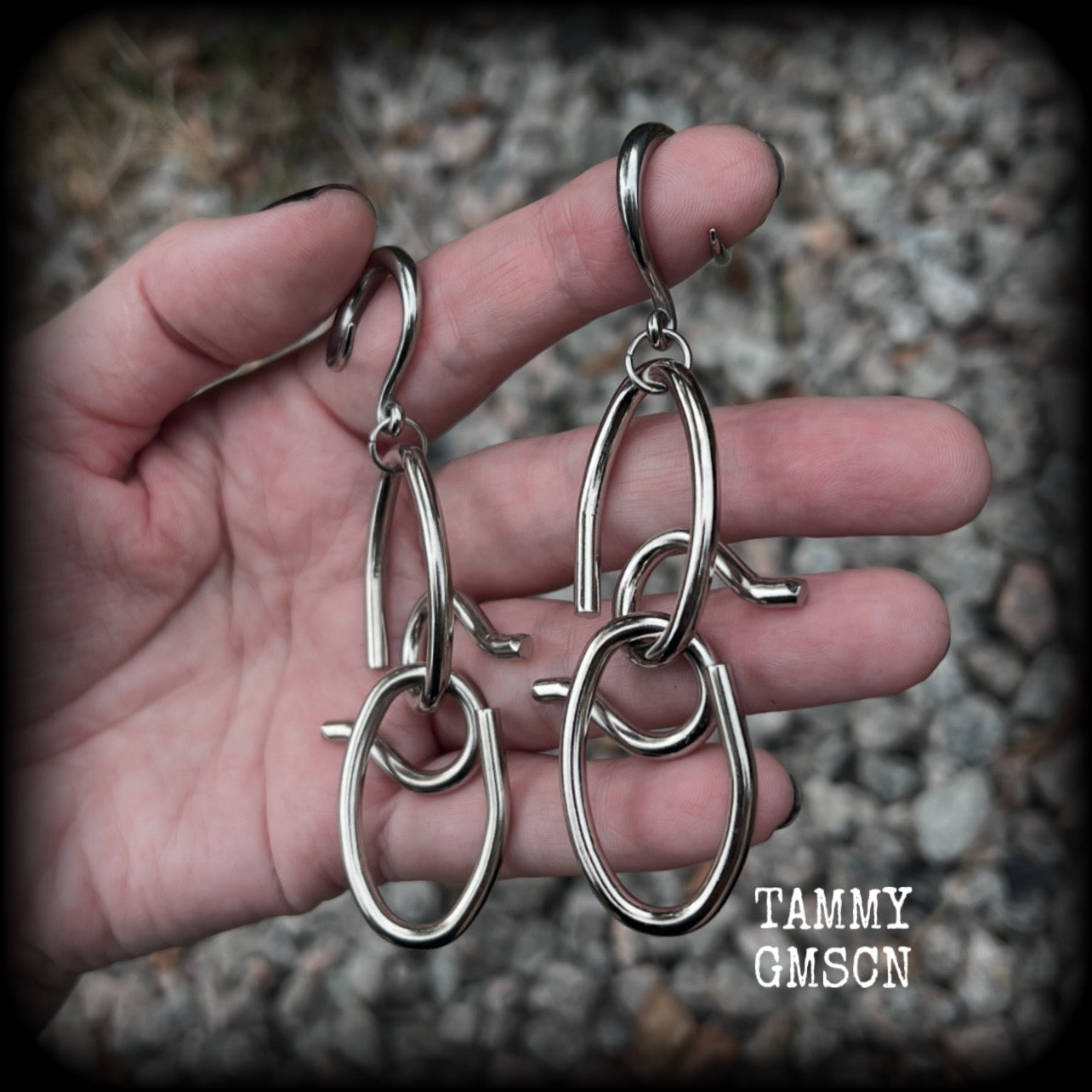 These awesome gauged earrings feature twisted and knotted surgical steel pieces, weighing approx 18 grams a piece, and nice and dangly at just over 9cms from tip to tip.

This pair has been made on 6 gauge (4mm) surgical steel full curl hooks, suitable for stretched lobes.