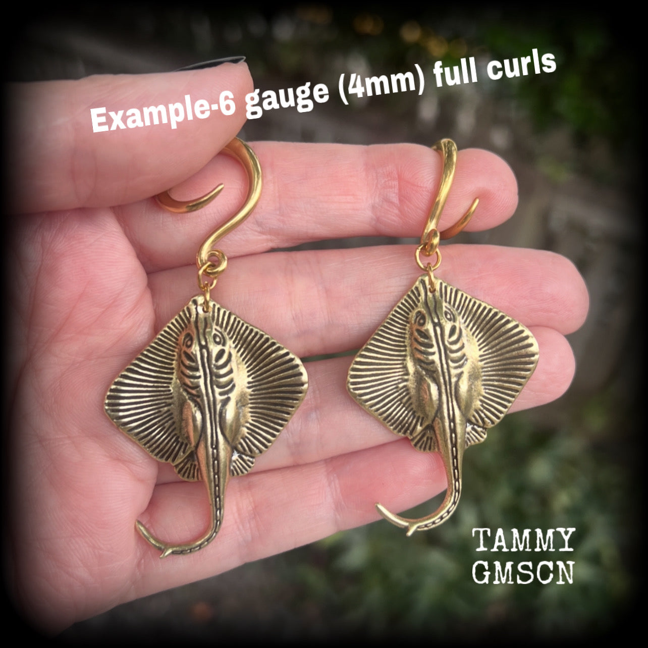 🔥 Symbolically, the stingray embodies calmness under pressure, self-defense, and navigating life's challenges with strength and balance.  

These awesome ear hangers feature a pair of brass sting rays, measuring just on 7cms from tip to tip, and weighing approx 17 grams each.

This pair has been made on 6 gauge (4mm) surgical steel full curls, suitable for stretched lobes.

