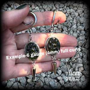 This pair of earrings features gorgeous forest green moldavite gemstones in a boho antique silver setting, weighing approx 10 grams a piece and measuring just on 8cms from tip to tip.  This pair have been made on 6 gauge (4mm) surgical steel full curl hooks, to be worn in stretched lobes.