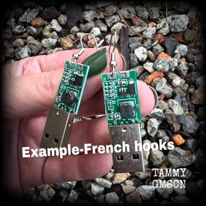 These awesome cyberpunk earrings feature a classic green USB, are nice and dangly, measuring just under 6cms from tip to tip, and nice and light weight, weighing only a few grams each.

This pair has been made on stainless steel french hooks, to be worn in pierced ears.