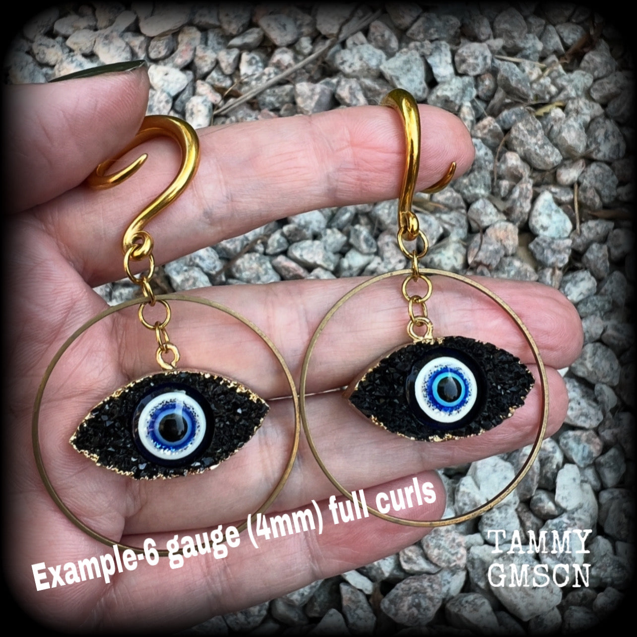 These unique evil eye gauged earrings feature a faux druzy greek evil eye, weighing approx 6 grams each, and are nice and dangly, hanging just on 7cms from tip to tip.

This pair have been made on 6 gauge (4mm) surgical steel full curl hooks, suitable for stretched lobes.