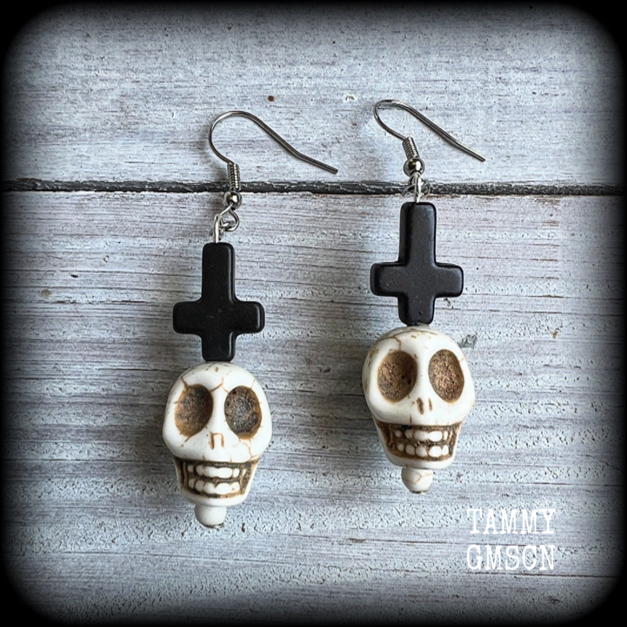 Inspired by Baron Samedi these earrings features pitch black inverted crosses with bone white skulls, measuring 7cms from tip to tip and weighing 7 grams a piece.

This pair have been made with stainless steel french hooks, suitable for pierced ears.