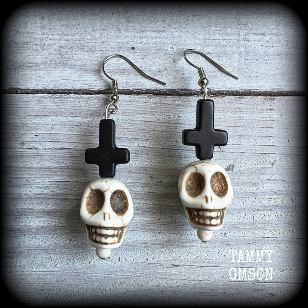 Inspired by Baron Samedi these earrings features pitch black inverted crosses with bone white skulls, measuring 7cms from tip to tip and weighing 7 grams a piece.

This pair have been made with stainless steel french hooks, suitable for pierced ears.
