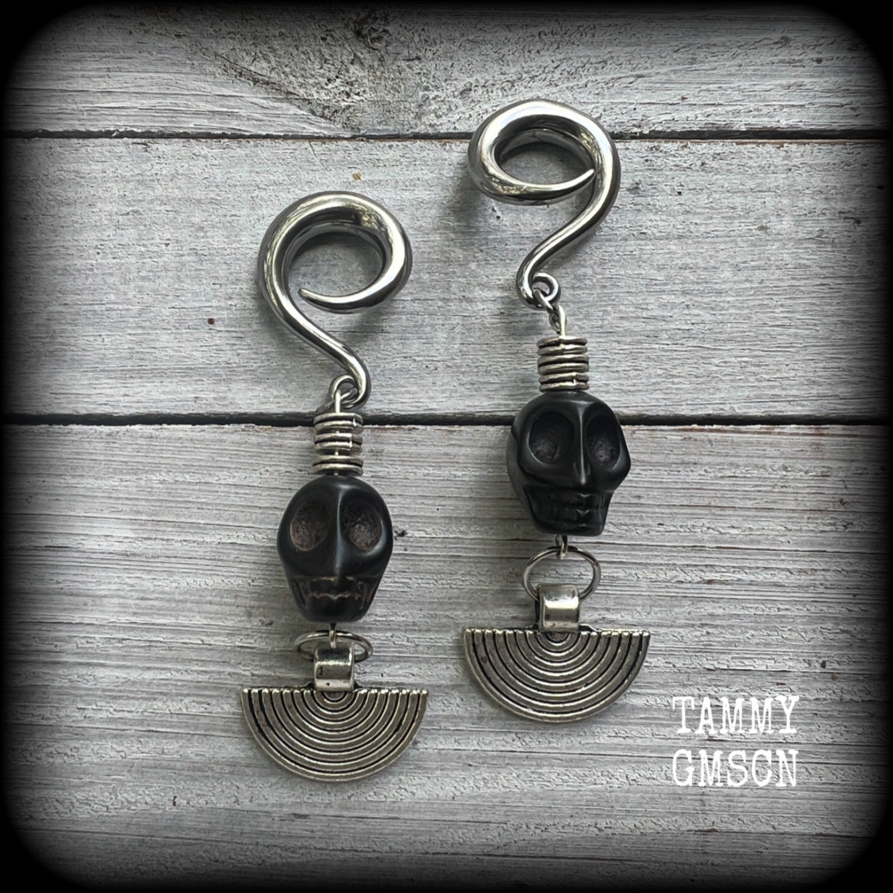 These gorgeous black stone skull and antique silver tribal gauged earrings measure just under 9cms from tip to tip and weigh in at 16 grams a piece.

This pair has been made on 2 gauge (6mm) surgical steel full curl hooks, to be worn in stretched lobes.