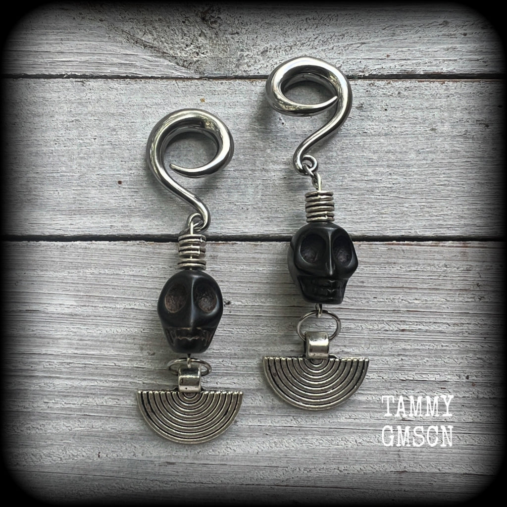 These gorgeous black stone skull and antique silver tribal gauged earrings measure just under 9cms from tip to tip and weigh in at 16 grams a piece.

This pair has been made on 2 gauge (6mm) surgical steel full curl hooks, to be worn in stretched lobes.