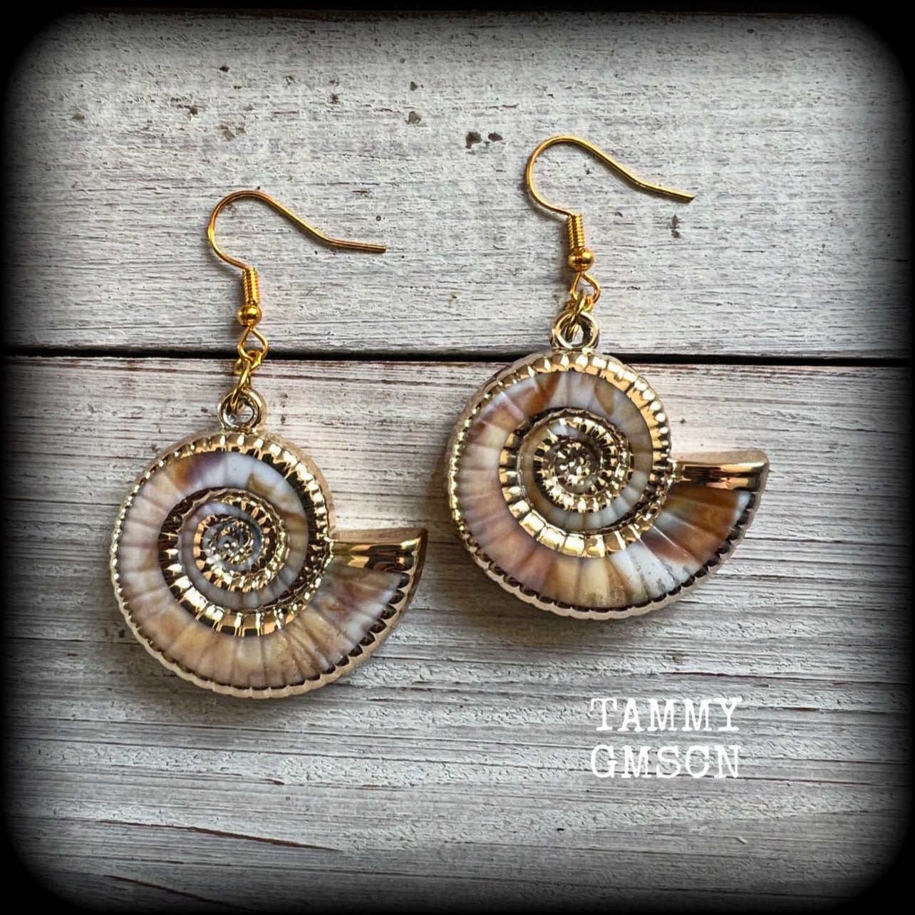 This pair of earrings feature gorgeous acrylic nautilus sea shells, super lightweight- weighing 6 grams each, measuring just approx 6cms from tip to tip. 

These beautiful earrings have been made with antique gold french hooks-for pierced ears.