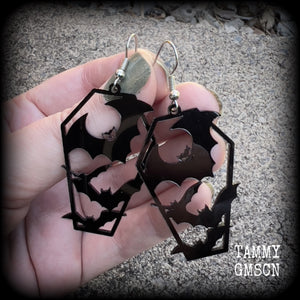 These awesome earrings feature pitch black acrylic coffins filled with bats! These earrings measure just over 6 cms from tip to tip and are nice and lightweight at only a few grams each.

This pair have been made on stainless steel french hooks, to be worn in pierced ears.