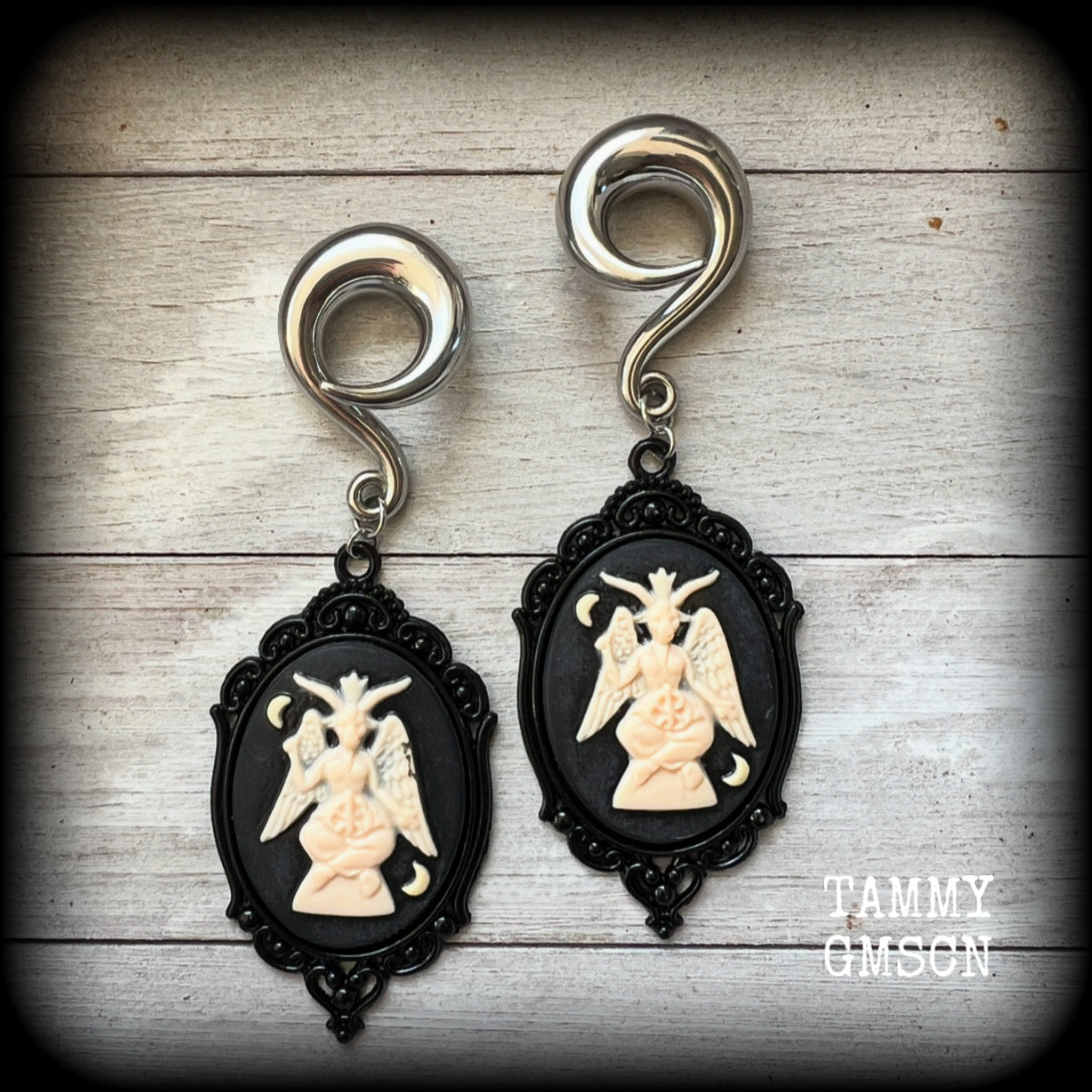Featuring gorgeous ivory and black enamel Baphomet pendants, these gauged earrings measure just on 10.5cms from tip to tip, and weigh approx 32 grams each.

This pair have been made on 00 gauge (10mm) surgical steel full curls, to be worn in stretched lobes.