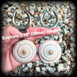 These gauged earrings feature beautiful big Giant sundail sea snail shells weighing in at 25 grams a piece, and nice and dangly at just over 10cms from tip to tip. 
This pair has been made on 1.18” gauge (30mm) surgical steel cradles