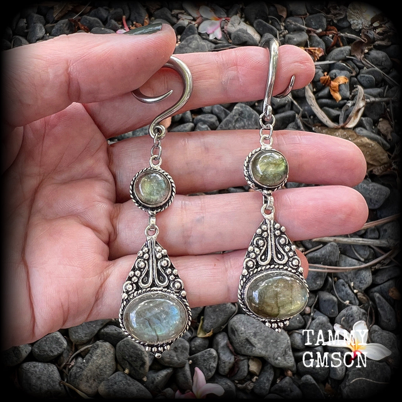 Made with shimmering polished labradorite gemstones, measuring 8.5cms from tip to tip, and weighing approx 10 grams each, not too heavy...
These earrings have been made on 6 gauge (4mm) surgical steel full curl hooks, to be worn in stretched lobes.