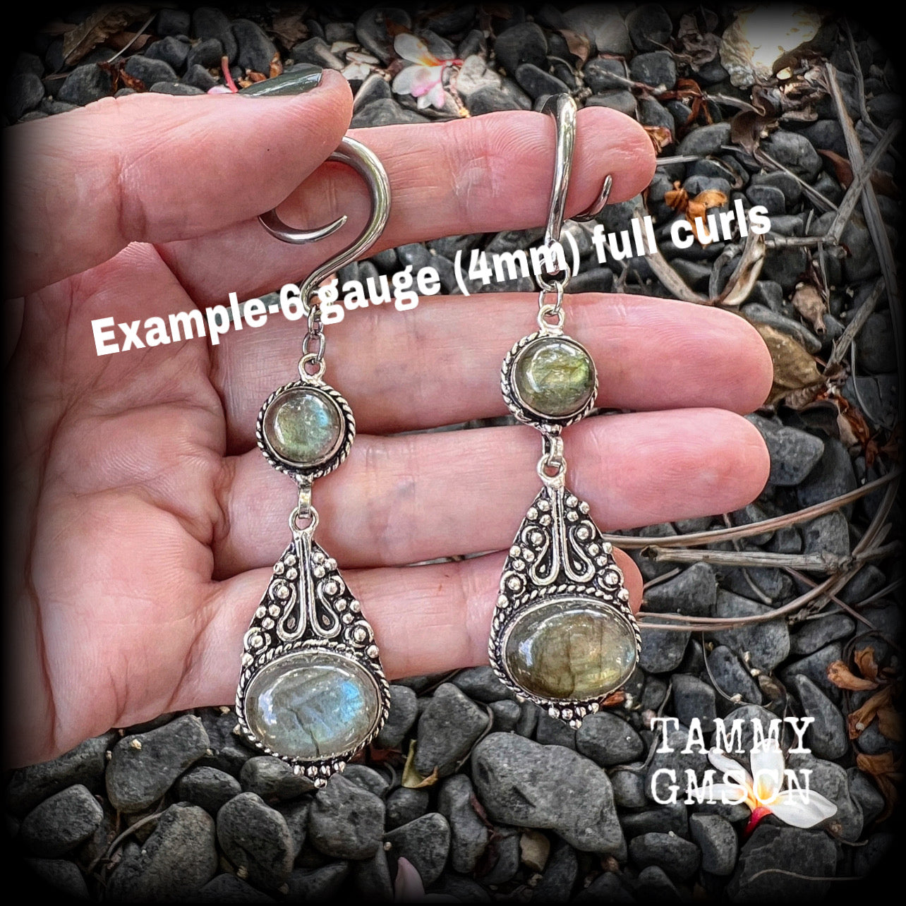 Made with shimmering polished labradorite gemstones, measuring 8.5cms from tip to tip, and weighing approx 10 grams each, not too heavy...
These earrings have been made on 6 gauge (4mm) surgical steel full curl hooks, to be worn in stretched lobes.