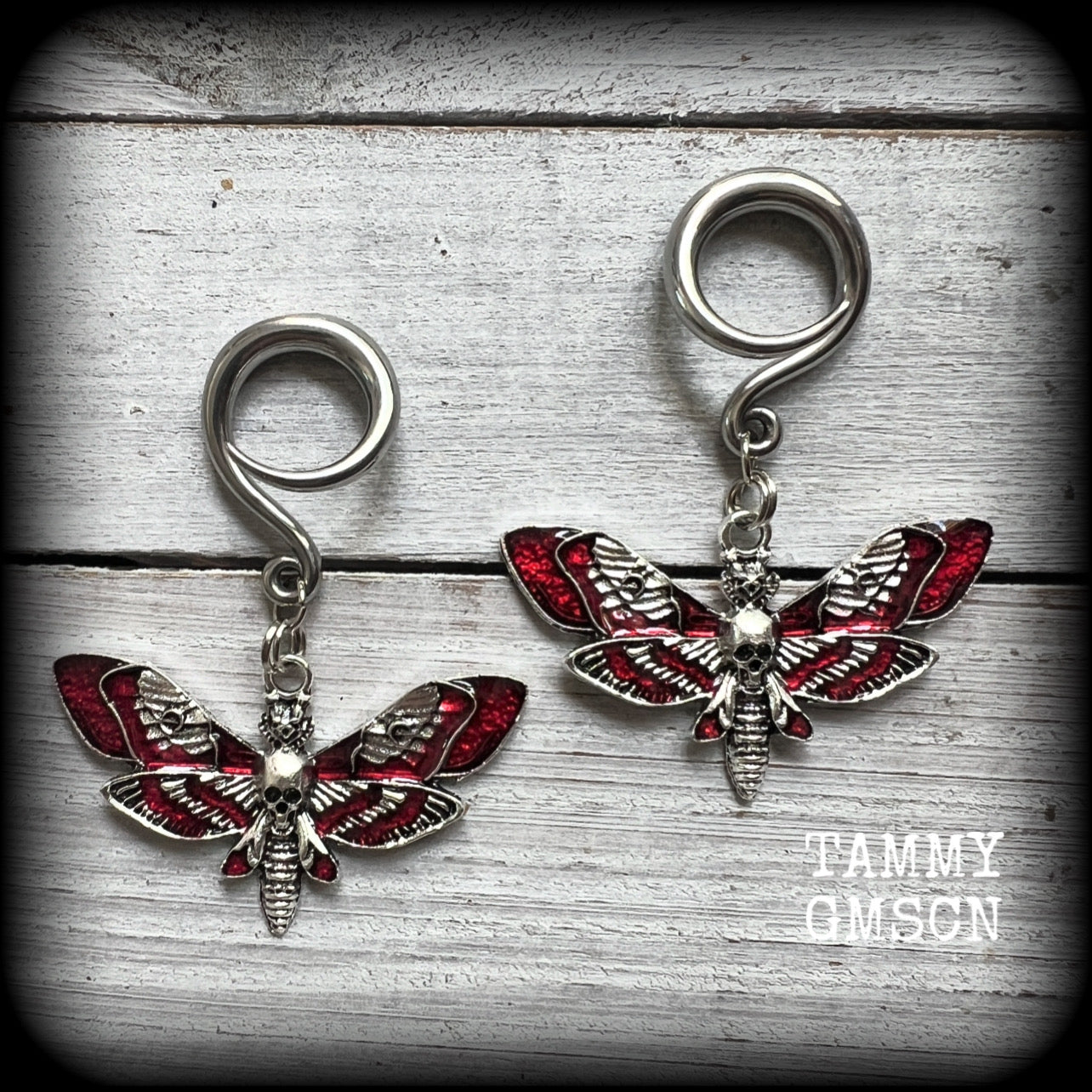 Featuring an awesome antique silver and red enamel deathshead moth charm, these earrings measure just on 5cms from tip to tip, and weigh approx 6 grams each.

This pair has been made on 6 gauge (4mm) stainless steel full curl hooks, suitable for stretched lobes.
