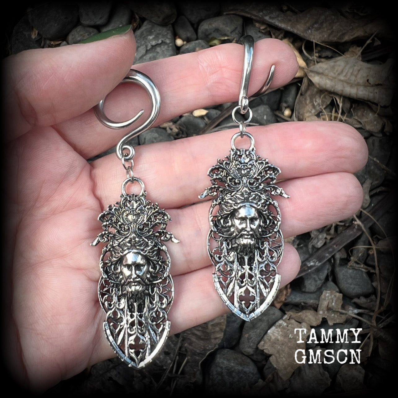 These gorgeous gothic antique silver gauged earrings feature beautiful baroque architecture with the face of Zeus-strong, commanding and masculine, depicted with flowing hair and moustache.

These earrings measure just on 8cms from tip to tip, and weighing approx 15 grams each.

This pair has been made on 6 gauge (4mm) surgical steel full curls, to be worn in stretched lobes.