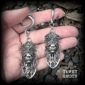These gorgeous gothic antique silver gauged earrings feature beautiful baroque architecture with the face of Zeus-strong, commanding and masculine, depicted with flowing hair and moustache.

These earrings measure just on 8cms from tip to tip, and weighing approx 15 grams each.

This pair has been made on 6 gauge (4mm) surgical steel full curls, to be worn in stretched lobes.