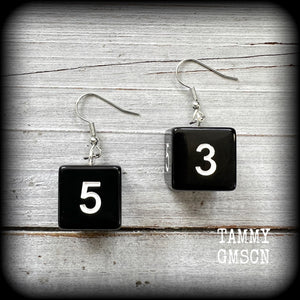 Featuring a pair of pitch black gamer dice, these super nerdy earrings measure just on 4cm from tip to tip and weigh approx 5 grams each.

This pair have been made with stainless steel french hooks, suitable for pierced ears.