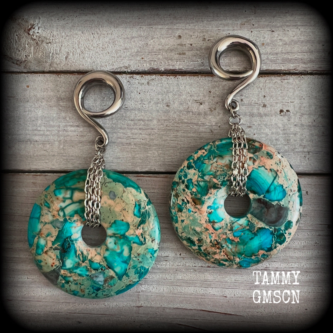 These ear weights feature gorgeous Turquoise ocean jasper donut gemstones cradled in antique silver chain, measuring just over 9cms from tip to tip, and weighing approx 40 grams each. 

This pair have been made on 2 gauge (6mm) surgical steel full curls, to be worn in stretched lobes.