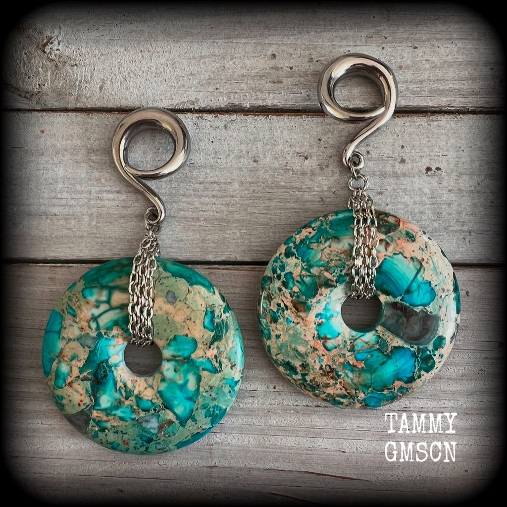 These ear weights feature gorgeous Turquoise ocean jasper donut gemstones cradled in antique silver chain, measuring just over 9cms from tip to tip, and weighing approx 40 grams each. 

This pair have been made on 2 gauge (6mm) surgical steel full curls, to be worn in stretched lobes.