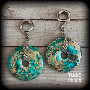 These ear weights feature gorgeous Turquoise ocean jasper donut gemstones cradled in antique silver chain, measuring just over 9cms from tip to tip, and weighing approx 40 grams each. 

This pair have been made on 2 gauge (6mm) surgical steel full curls, to be worn in stretched lobes.