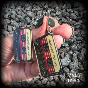 This awesome pair of earrings features a pair of classic 80’s mix tapes, are nice and lightweight weighing only a few grams each, and measure approx 7cms from tip to tip.

This pair has been made on stainless steel french hooks, suitable for pierced ears.