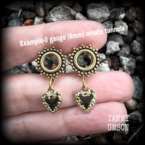 These stunning tunnel earrings feature gorgeous antique gold heart charms, and are nice and lightweight, weighing only a few grams each, measuring just under 4cms from tip to tip.

This pair has been made on 0 gauge (8mm) ornate surgy steel screw fit tunnels-for stretched lobes.