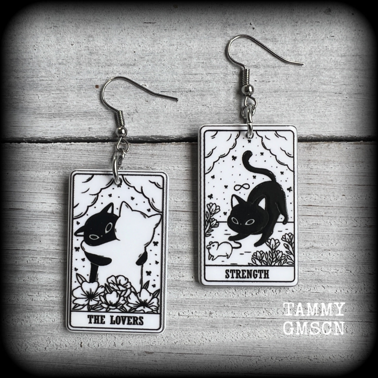 These adorable cat tarot earrings feature The Lovers and Strength lightweight tarot card charms, weighing only a few grams each, and measure approx 5cms from tip to tip.

This pair has been made with stainless steel french hooks, for pierced ears.
