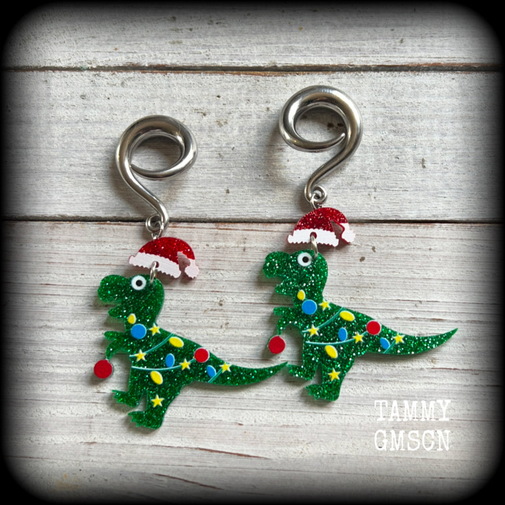Featuring festive dinosaurs draped in colourful Christmas tree lights complete with Santa hats, these adorable earrings weigh in at 9 grams a piece, and measure approx 8cms from tip to tip.

This pair has been made on 2 gauge (6mm) surgical steel full curl hooks, to be worn in stretched lobes.