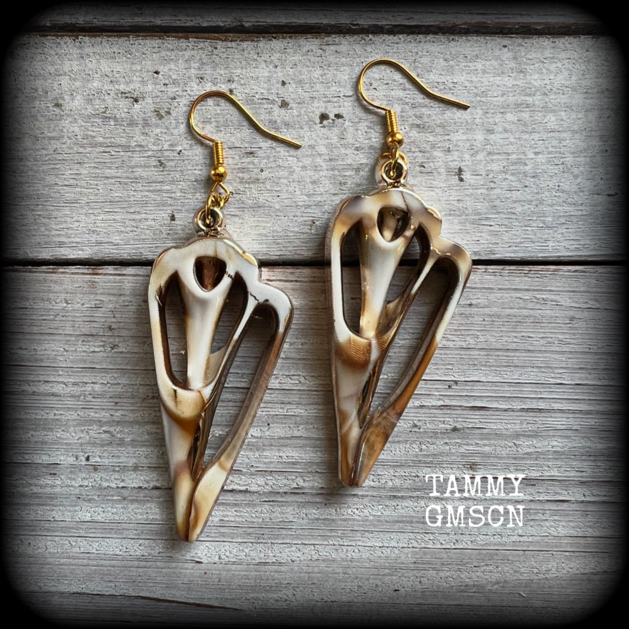 These earrings feature gorgeous acrylic conch sea shell slices , super lightweight- weighing only a few grams each, and nice and dangly, measuring just on 7cms from tip to tip. 

These beautiful earrings have been made with antique gold french hooks-for pierced ears.