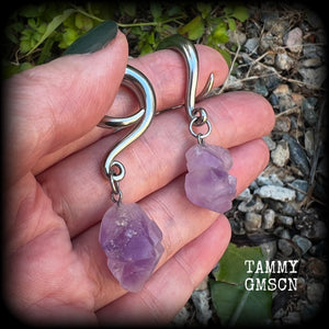 These gorgeous gauged earrings feature beautiful purple raw amethyst gemstones, measuring just under 6cms from tip to tip, and weighing approx 10 grams each, not too heavy...

This pair have been made on 2 gauge (6mm) surgical steel full curl hooks, to be worn in stretched lobes.