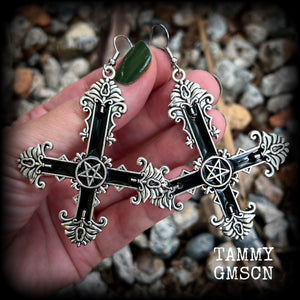 These gorgeous gothic earrings feature a black enamel inverted cross with a silver inverted pentagram, measuring just on 8.5 cms from tip to tip, and weigh approx 10 grams a piece.

This pair have been made on stainless steel french hooks, suitable for pierced ears.
