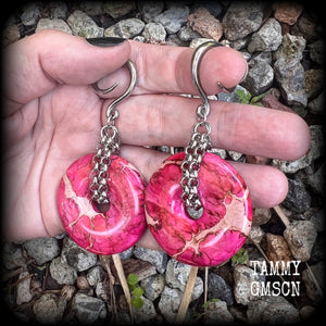 This pair of gorgeous ocean jasper earrings features beautiful pink marbled donut gemstones, weighing approx 19 grams a piece, and measuring 8cms from tip to tip.

This pair has been made on 6 gauge (4mm) surgical steel full curl hooks, to be worn in stretched lobes.
