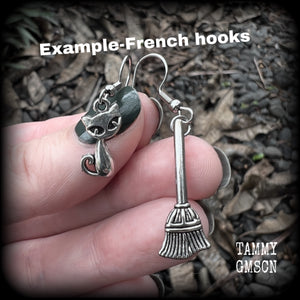 These cute earrings feature antique silver cats and witches brooms! These earrings are nice and light weight at only a few grams each, and nice and dangly, measuring 3- 5cms from tip to tip.
This pair has been made on stainless steel french hooks, suitable for pierced ears.