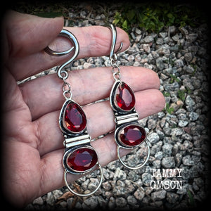 These stunning dangly gauged earrings feature gorgeous deep red faceted garnet gemstones in an ornate antique silver hinged setting, measuring just over 8cms from tip to tip, and weigh approx 10 grams each.  This pair have been made with 6 gauge (4mm) surgical steel full curl hooks, to be worn in stretched lobes.