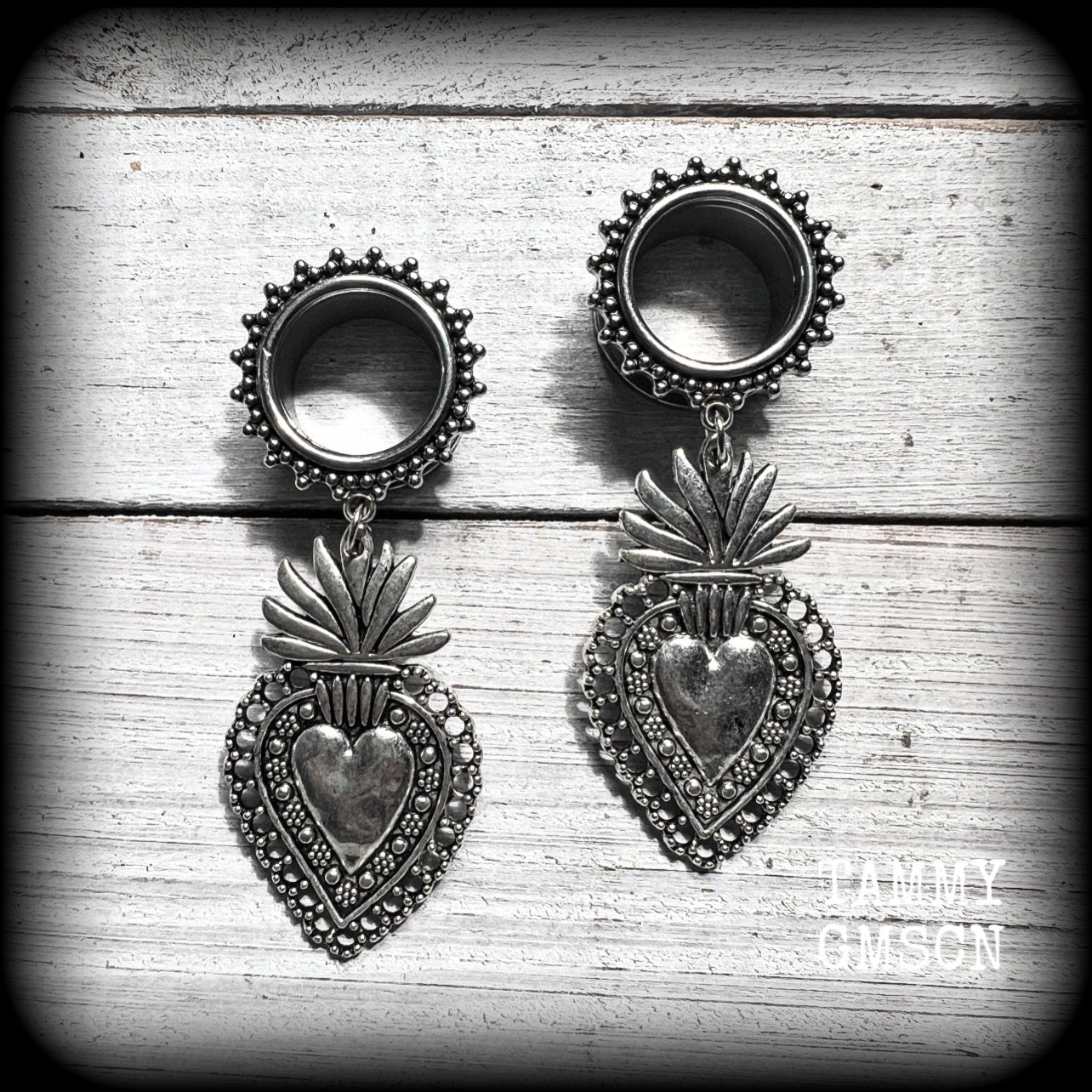These gorgeous tunnel earrings feature beautiful antique silver sacred hearts, are nice and lightweight, weighing approx 10 grams each and measure just under 7cms from tip to tip.

This pair has been made with 9/16" (14mm) gauge ornate surgical steel screw fit tunnels.