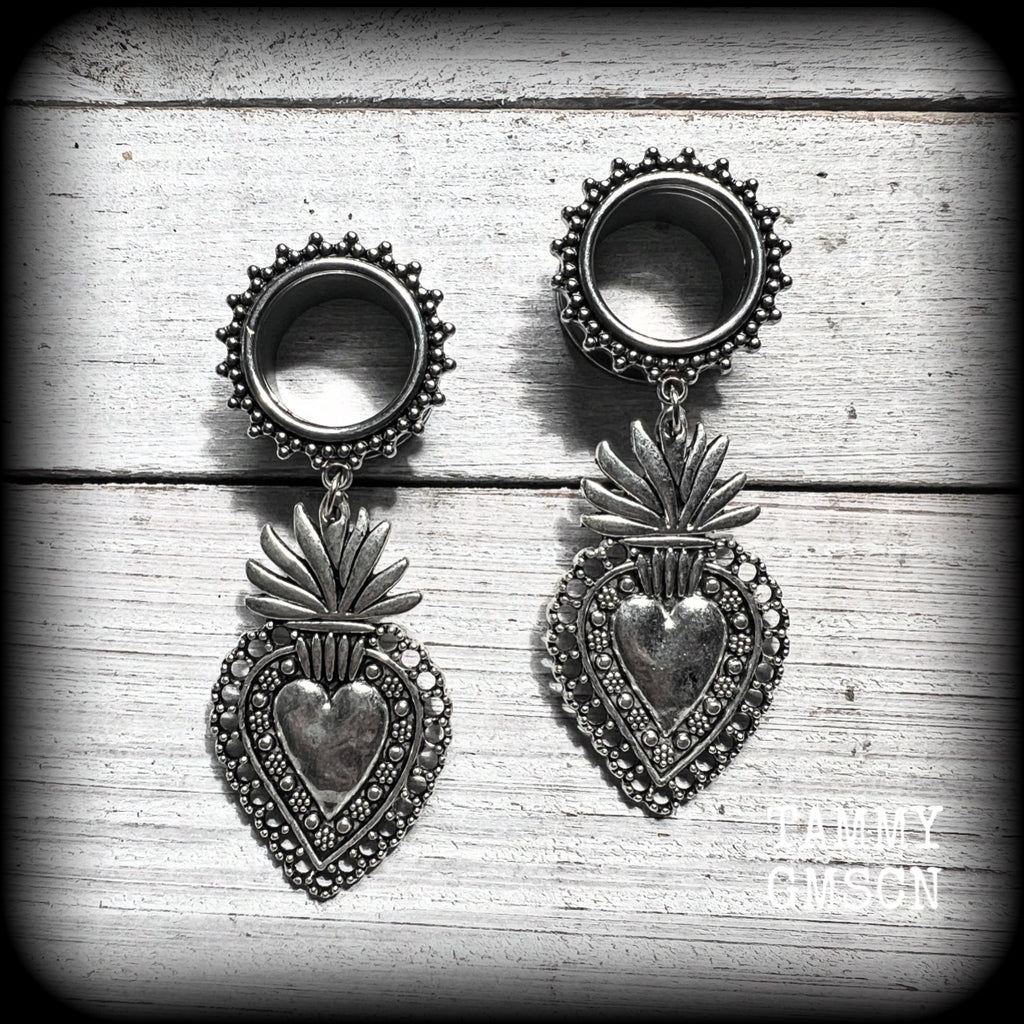 These gorgeous tunnel earrings feature beautiful antique silver sacred hearts, are nice and lightweight, weighing approx 10 grams each and measure just under 7cms from tip to tip.

This pair has been made with 9/16" (14mm) gauge ornate surgical steel screw fit tunnels.