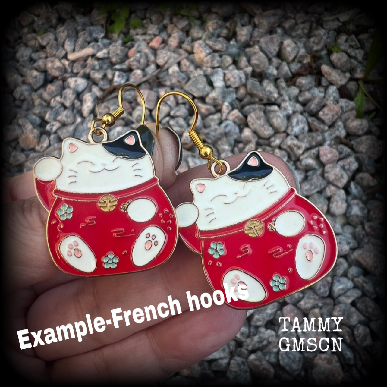 Featuring red and white maneki neko cat charms, theses earrings measure just under 5cms from tip to tip, and weigh only a few grams each.

This pair have been made with antique gold french hooks, suitable for pierced ears.