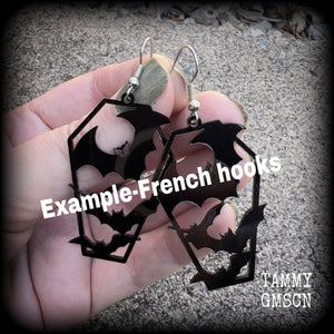 These awesome earrings feature pitch black acrylic coffins filled with bats! These earrings measure just over 6 cms from tip to tip and are nice and lightweight at only a few grams each.

This pair have been made on stainless steel french hooks, to be worn in pierced ears.