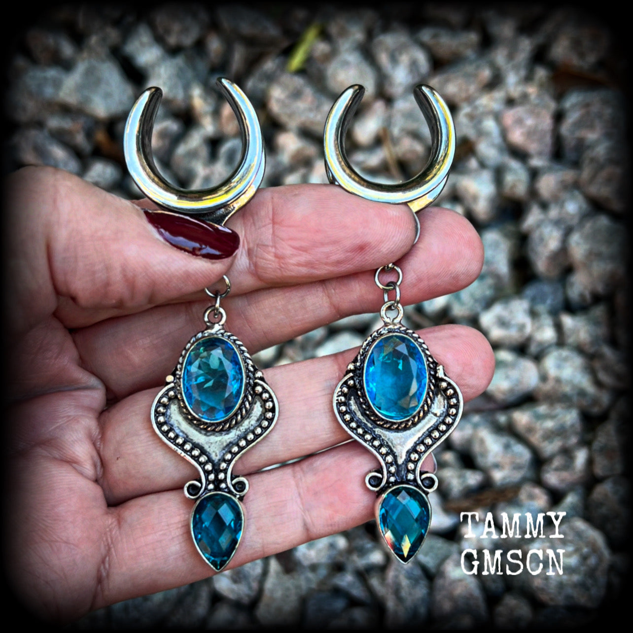 These earrings feature gorgeous facet blue topaz gemstones in a beautiful boho antique silver setting, lovely and dangly at just on 8cms from tip to tip, and not too heavy at 12 grams each.

These earrings have been made on 3/4” gauge (19mm) surgical steel cradles, to be worn in stretched lobes.