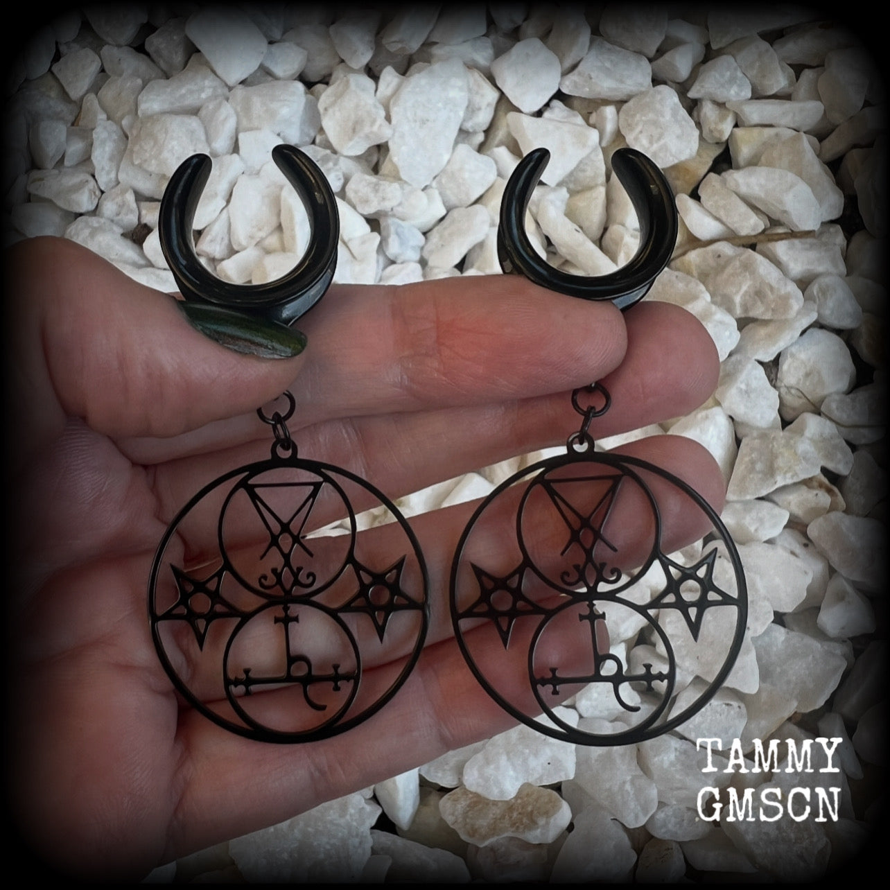 These gorgeous stainless steel earrings feature the Sigil of Lilith with the Sigil of Lucifer flanked by inverted pentagrams on each side. These earrings are lovely and light weight, weighing approx 9 grams each, and measure just on 7.5 cms from tip to tip.

This pair has been made on 3/4” gauge (19mm) surgical steel cradle hooks, to be worn in stretched lobes.