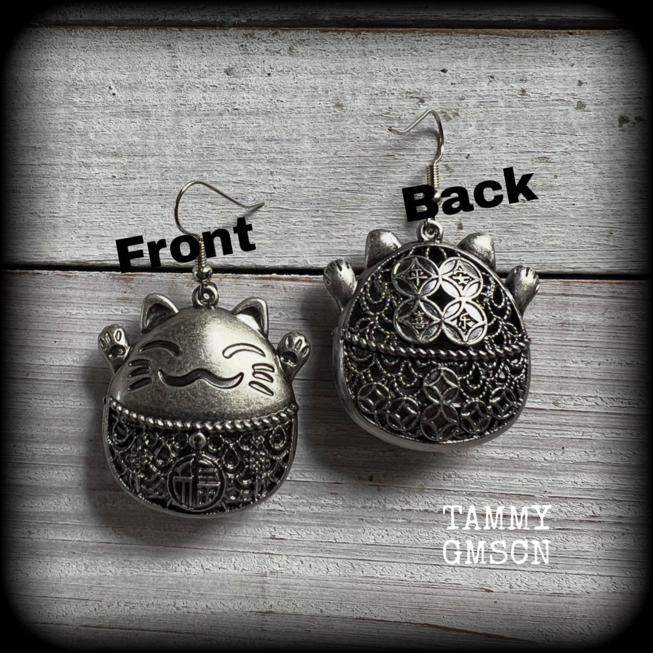 These gorgeous earrings features antique silver happy cat charms with the symbol for ‘good fortune’ on its tummy, measuring just on 5cms from tip to tip, and weighing approx 8 grams each.

This pair have been made on stainless steel french hooks, for pierced ears.