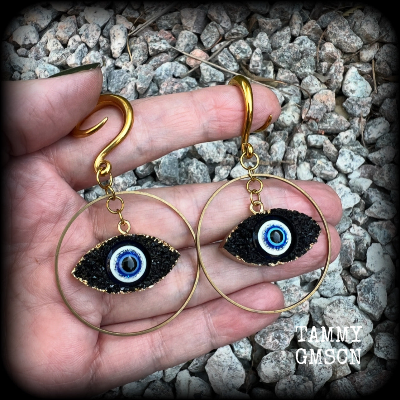 These unique evil eye gauged earrings feature a faux druzy greek evil eye, weighing approx 6 grams each, and are nice and dangly, hanging just on 7cms from tip to tip.

This pair have been made on 6 gauge (4mm) surgical steel full curl hooks, suitable for stretched lobes.