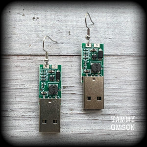 These awesome cyberpunk earrings feature a classic green USB, are nice and dangly, measuring just under 6cms from tip to tip, and nice and light weight, weighing only a few grams each.

This pair has been made on stainless steel french hooks, to be worn in pierced ears.