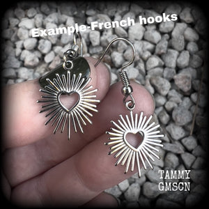 These adorable antique silver sacred heart earrings are nice and lightweight at only a gram or two a piece, and not too dangly, measuring just on 4cms from tip to tip.

This pair has been made on stainless steel french hooks to be worn through pierced ears.