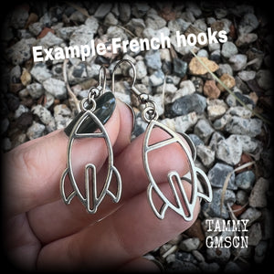 This pair of super cute antique silver space rocket earrings measures just 4cms from tip to tip, and weigh only a few grams each (nice and light weight).

This pair has been made on stainless steel french hooks, suitable for pierced ears.


