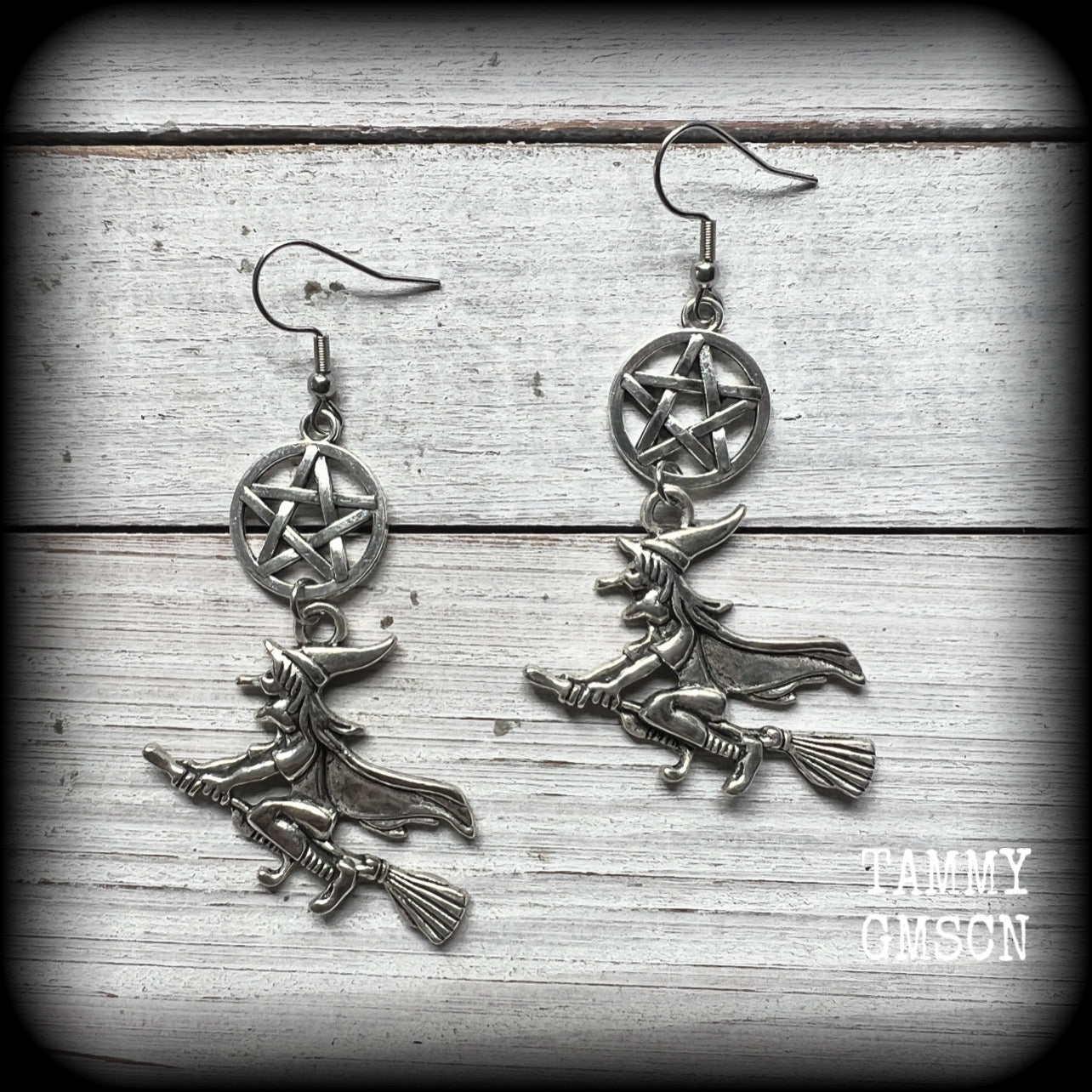 This pair of earrings feature a classic antique silver witch flying on her broomstick dangling from a silver pentagram, are nice and light weight at only 5 grams each, and nice and dangly, measuring just over 7cms from tip to tip.

This pair has been made on stainless steel french hooks, suitable for pierced ears.